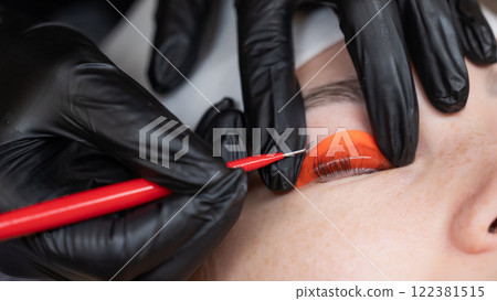 Caucasian woman undergoing eyelash lamination procedure.  122381515