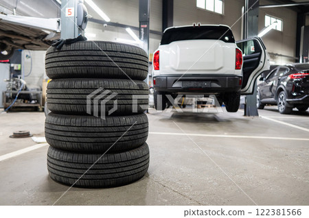 Changing tires for a car according to the season.  122381566