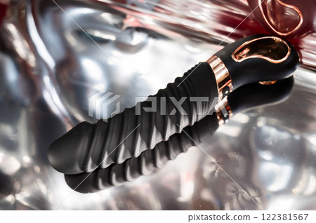 Sex toy on metal background.  122381567