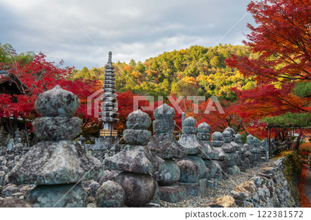 Stone pagoda by fall maple leaves at Adashino temple, Arashiyama 122381572