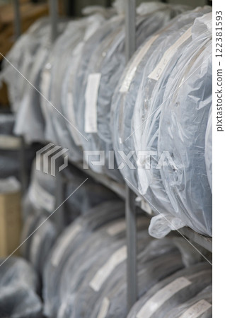 New car tires in plastic bags in a store. New car tires in plastic bags in a store. 122381593