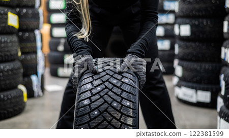 Mechanic keeps new studded car tires in garage.  122381599