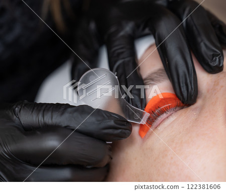 Caucasian woman undergoing eyelash lamination procedure.  122381606