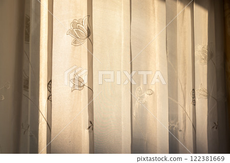 薄薄的蕾絲窗簾擋住了夕陽 薄薄的蕾絲窗簾擋住了夕陽 122381669