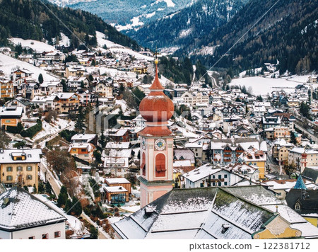 Aerial drone view of the Ortisei town covered in snow in northern Italy 122381712