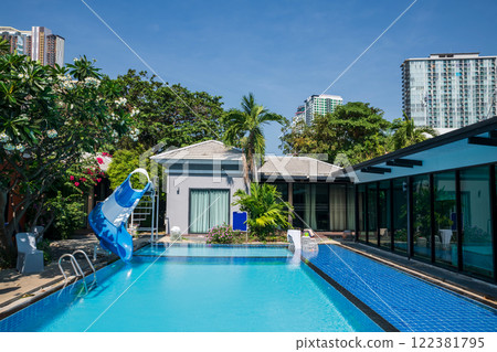 Swimming pool with slider against blue sky at luxury resort 122381795