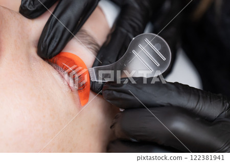 Caucasian woman undergoing eyelash lamination procedure.  122381941