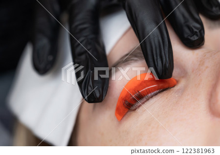 Caucasian woman undergoing eyelash lamination procedure.  122381963