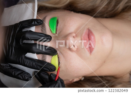 Caucasian woman undergoing eyelash lamination procedure. Caucasian woman undergoing eyelash lamination procedure. 122382049