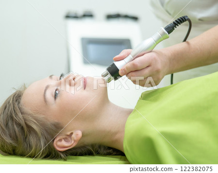 Caucasian woman undergoing radio wave RF lifting procedure in beauty salon.  122382075