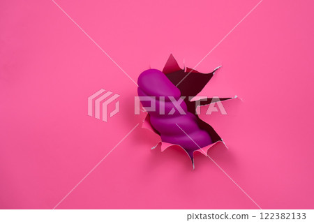 Raspberry sex toy sticks out of pink paper background. Copy space. Raspberry sex toy sticks out of pink paper background. Copy space. 122382133