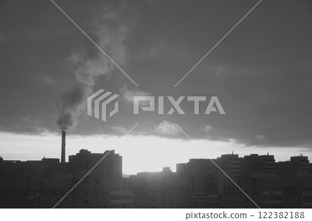 A dusk view of an industrial cityscape with heavy smoke emissions, symbolizing urban growth 122382188