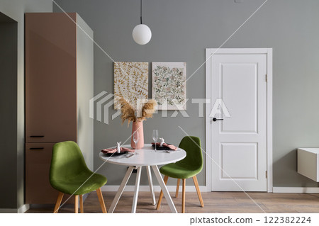 An Elegant and Stylish Dining Space Featuring Contemporary Decor with Vibrant Green Chairs An Elegant and Stylish Dining Space Featuring Contemporary Decor with Vibrant Green Chairs 122382224