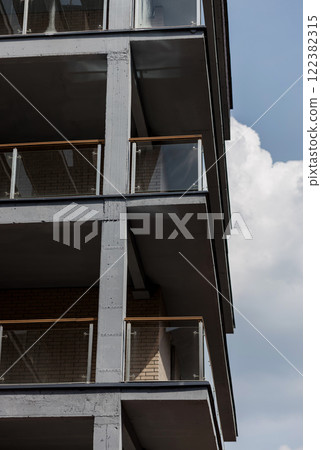 Contemporary apartment building with glass balconies 122382315