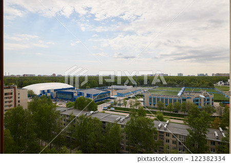 An Aerial View of a Modern Sports Complex, Which is Enveloped by Lush Greenery Around It An Aerial View of a Modern Sports Complex, Which is Enveloped by Lush Greenery Around It 122382334