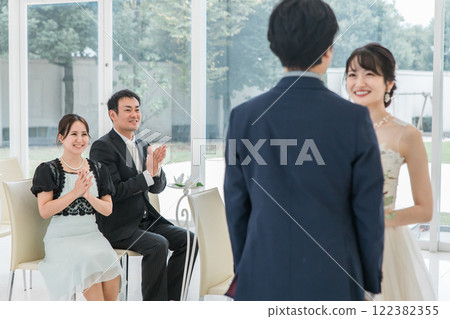 Men and women of smiling guests, attendees, attendees, friends who celebrate by applauding at the wedding ceremony Men and women of smiling guests, attendees, attendees, friends who celebrate by applauding at the wedding ceremony 122382355