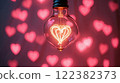 Romantic light bulb with heart design illuminating a background of pink heart patterns at night 122382373