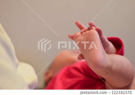 Baby playing with his feet 122382378