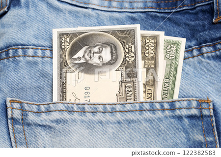 Old Philippine peso in the pocket of blue jeans Old Philippine peso in the pocket of blue jeans 122382583