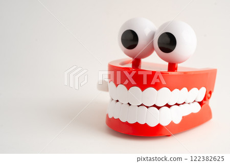 Funny red teeth with eye toy denture model for dental health care. 122382625