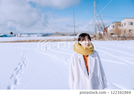 Playing in the snow with her 122382869