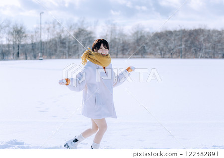 Playing in the snow with her 122382891