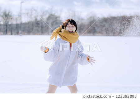 Playing in the snow with her 122382893
