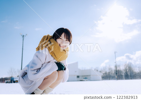 Playing in the snow with her 122382913