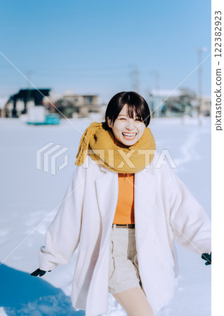 Playing in the snow with her 122382923