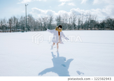 Playing in the snow with her 122382943