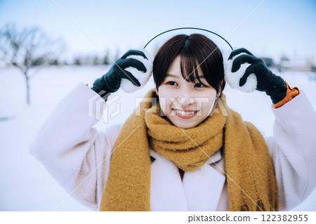 Playing in the snow with her 122382955