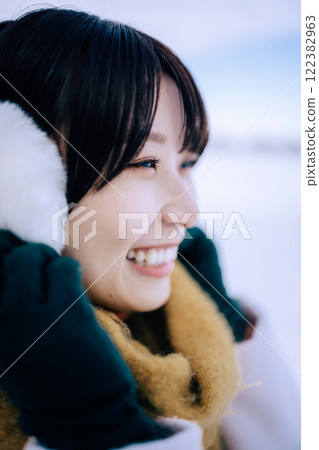 Playing in the snow with her 122382963