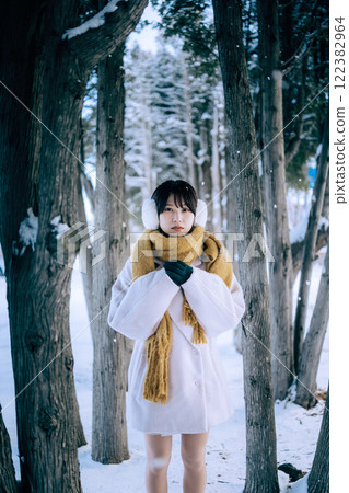 Playing in the snow with her 122382964