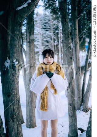 Playing in the snow with her 122382965