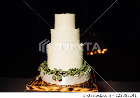 Premium square form wedding cake three floors at the evening ceremony 122383141