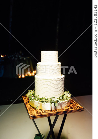 Premium square form wedding cake three floors at the evening ceremony 122383142