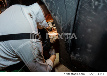 Sparks Fly as Mechanic Works on Metal Parts 122384441