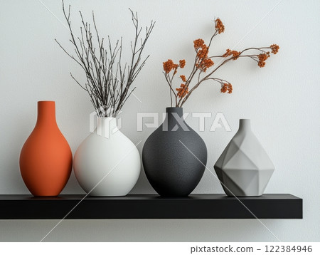 Contemporary interior featuring vases and minimalist decor against a white wall. 122384946
