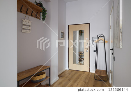 An Elegantly Modern and Stylish Home Entrance Featuring Beautiful Natural Accents 122386144