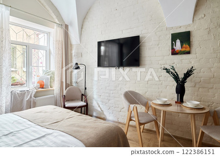 A Cozy Modern Bedroom that also features a Dining Area filled with Inviting Natural Light A Cozy Modern Bedroom that also features a Dining Area filled with Inviting Natural Light 122386151