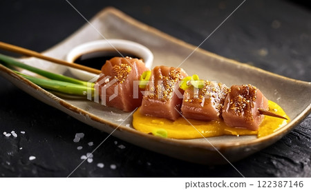 Delicious tuns Yakitori with saffron sauce and green onion Delicious tuns Yakitori with saffron sauce and green onion 122387146