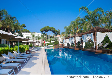 Swimming pool. Summer vacation at poolside. swimming pool in resort hotel for vacation leisure Swimming pool. Summer vacation at poolside. swimming pool in resort hotel for vacation leisure 122387793