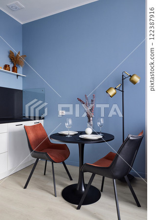 This modern dining space features stylish decor, creating a cozy atmosphere for dining 122387916