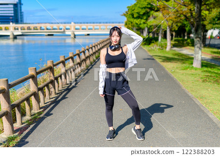 Cool woman walking along the river Posing Diet Walking Exercise 122388203