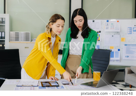 Creative digital development agency. developer team brainstorming on their project with laptop, smartphone and digital tablet. 122388248