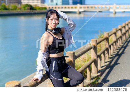 A cool woman sitting and posing while walking along the river Posing Diet Walking Exercise 122388476