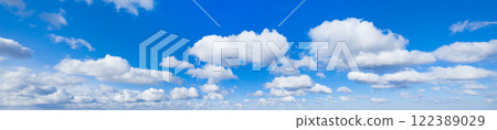 Panoramic fluffy cloud in the blue sky. Sky with cloud on a sunny day. 122389029