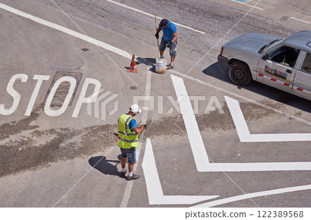 Workers painting bold road lines under midday sun, emphasizing safety on urban street, safety for drivers and pedestrians, safety as crucial focus of precise public traffic marking Workers painting bold road lines under midday sun, emphasizing safety on urban street, safety for drivers and pedestrians, safety as crucial focus of precise public traffic marking 122389568