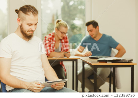 Student boy with tablet in front of her classmates 122389750