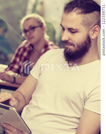 Student boy with tablet in front of her classmates Student boy with tablet in front of her classmates 122389751